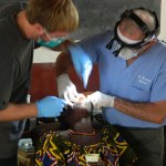 Dr. providing dental care to a woman in Togo.