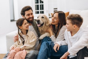 smiling family with their dog